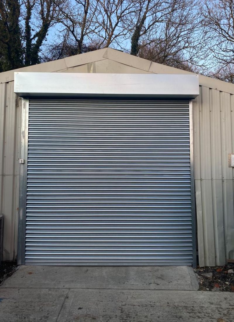 Open roller shutter revealing shop entrance – commercial store Scotland
